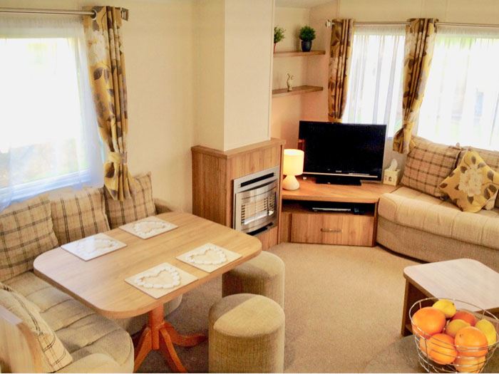 Double glazed and central heated caravan with a gated decking for hire at Waterside Holiday Park